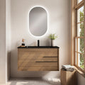Mobile bagno sospeso in legno con due cassetti, top nero e specchio ovale retroilluminato